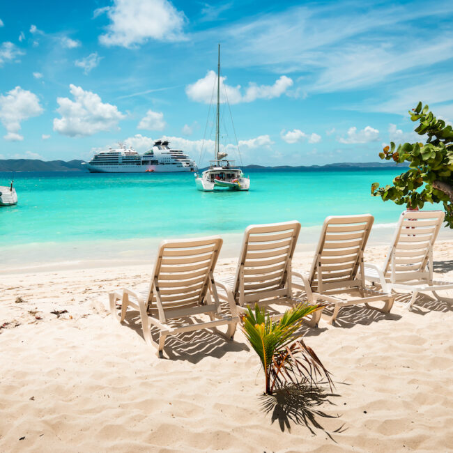 Tropical white sand beach with beach chairs. Jost Van dyke, British Virgin Islands.